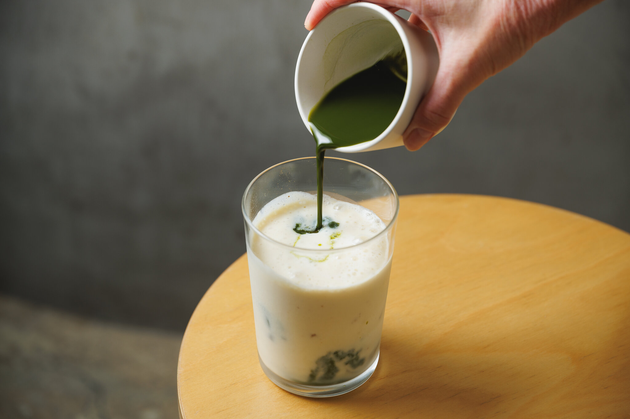 Pouring matcha into milk — the signature L for You pour